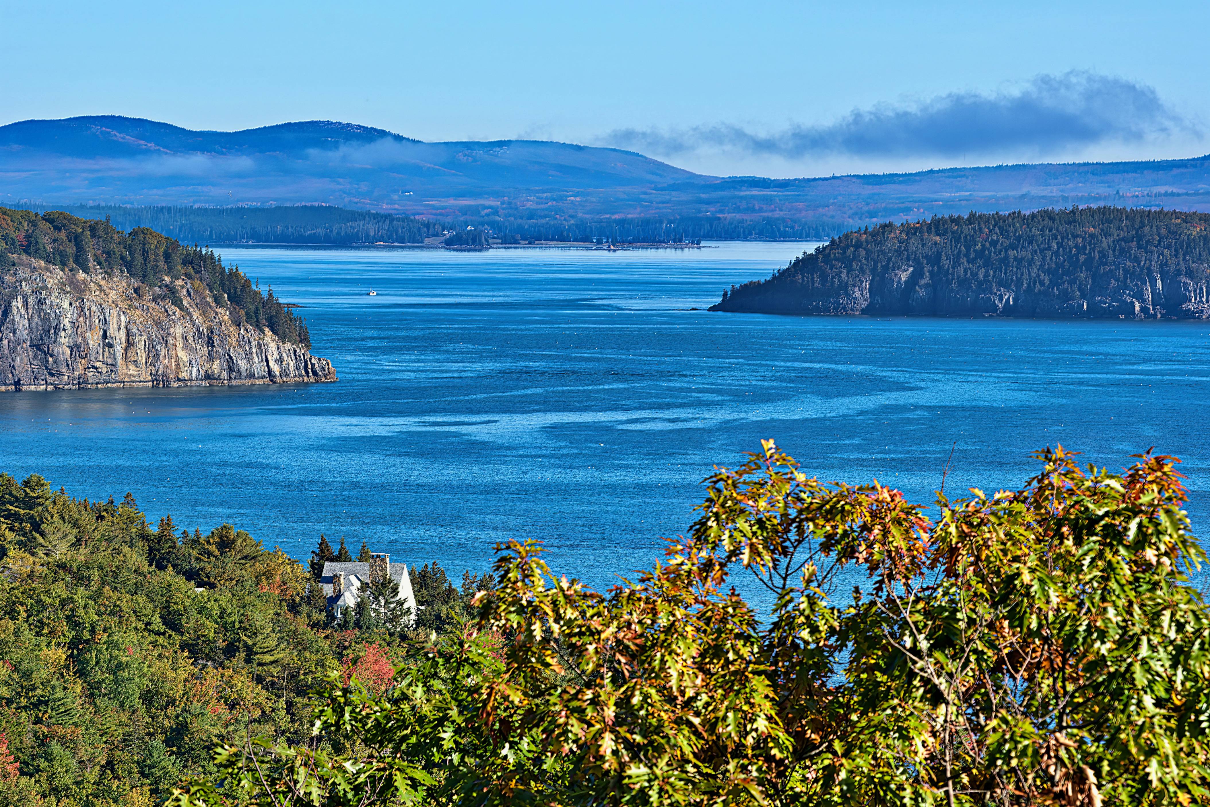 a scenic view of a lake surrounded by mountains